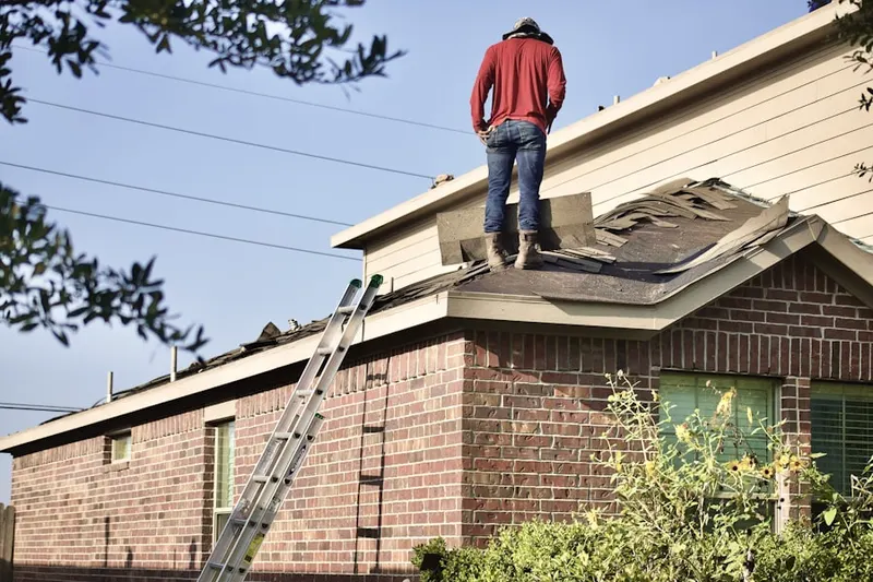 Professional roofer working on a residential roof in Quarterfield Farms